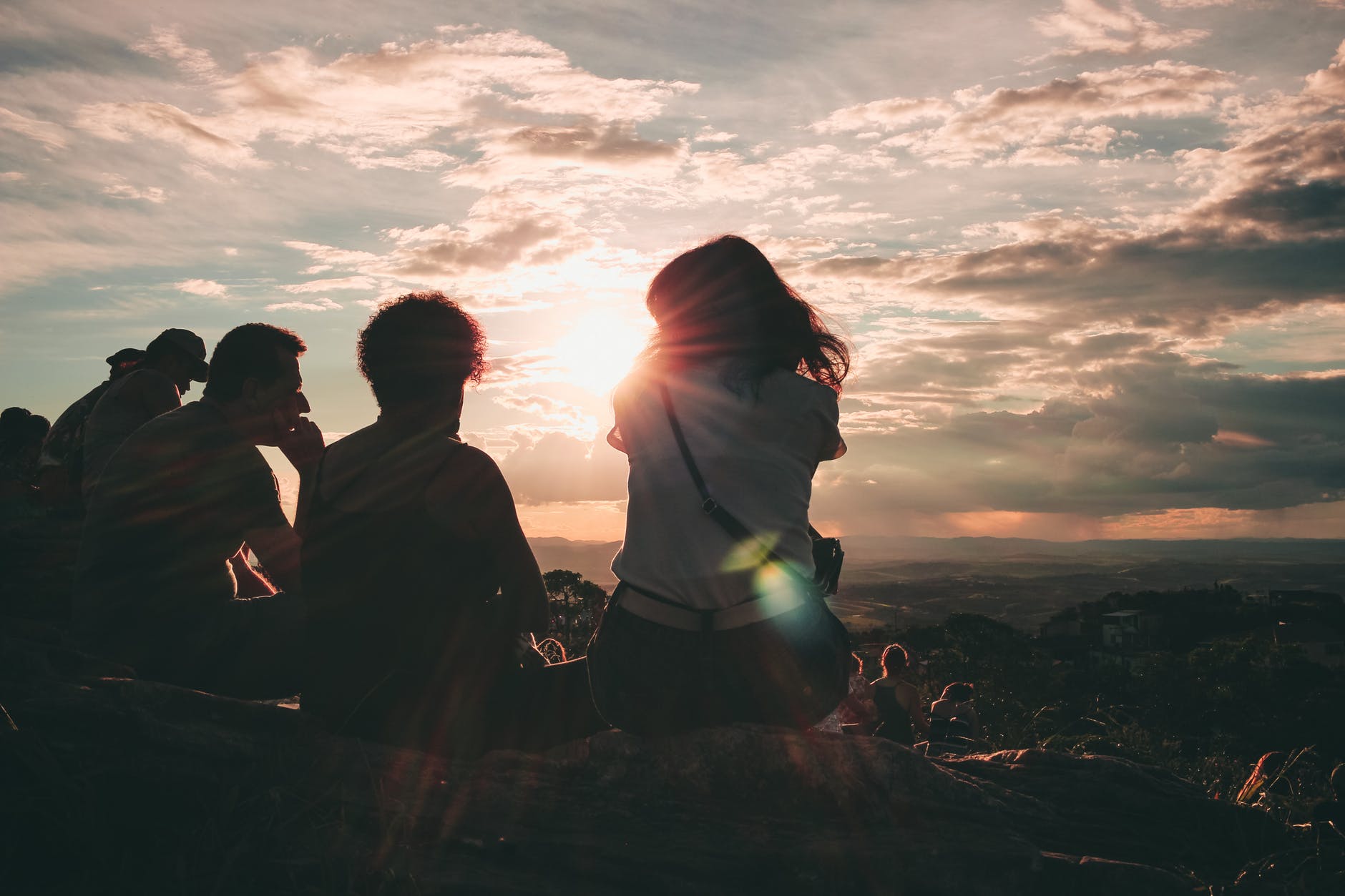 group of people sitting on hill