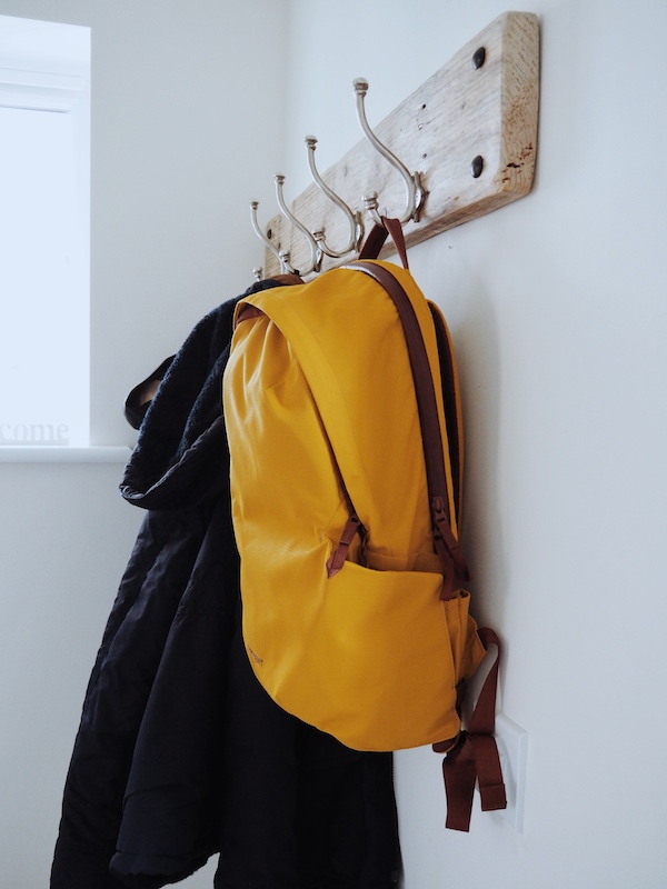 The Everything Backpack hung in a coat hook