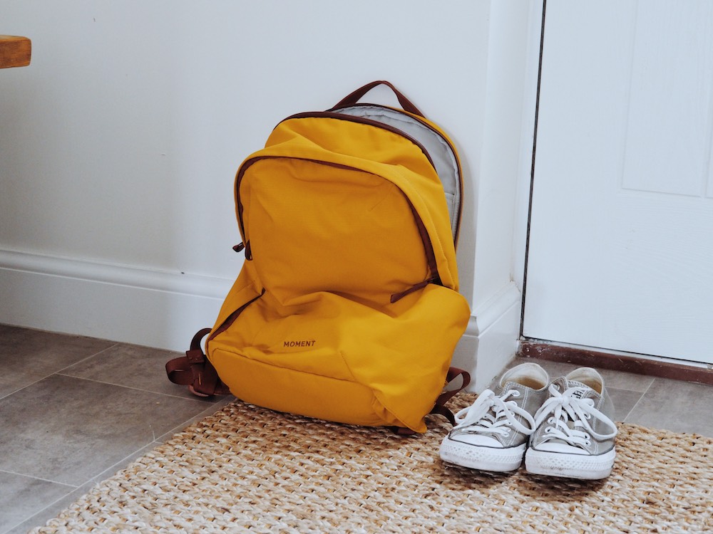 The Moment Travel Everything Backpack by the front door