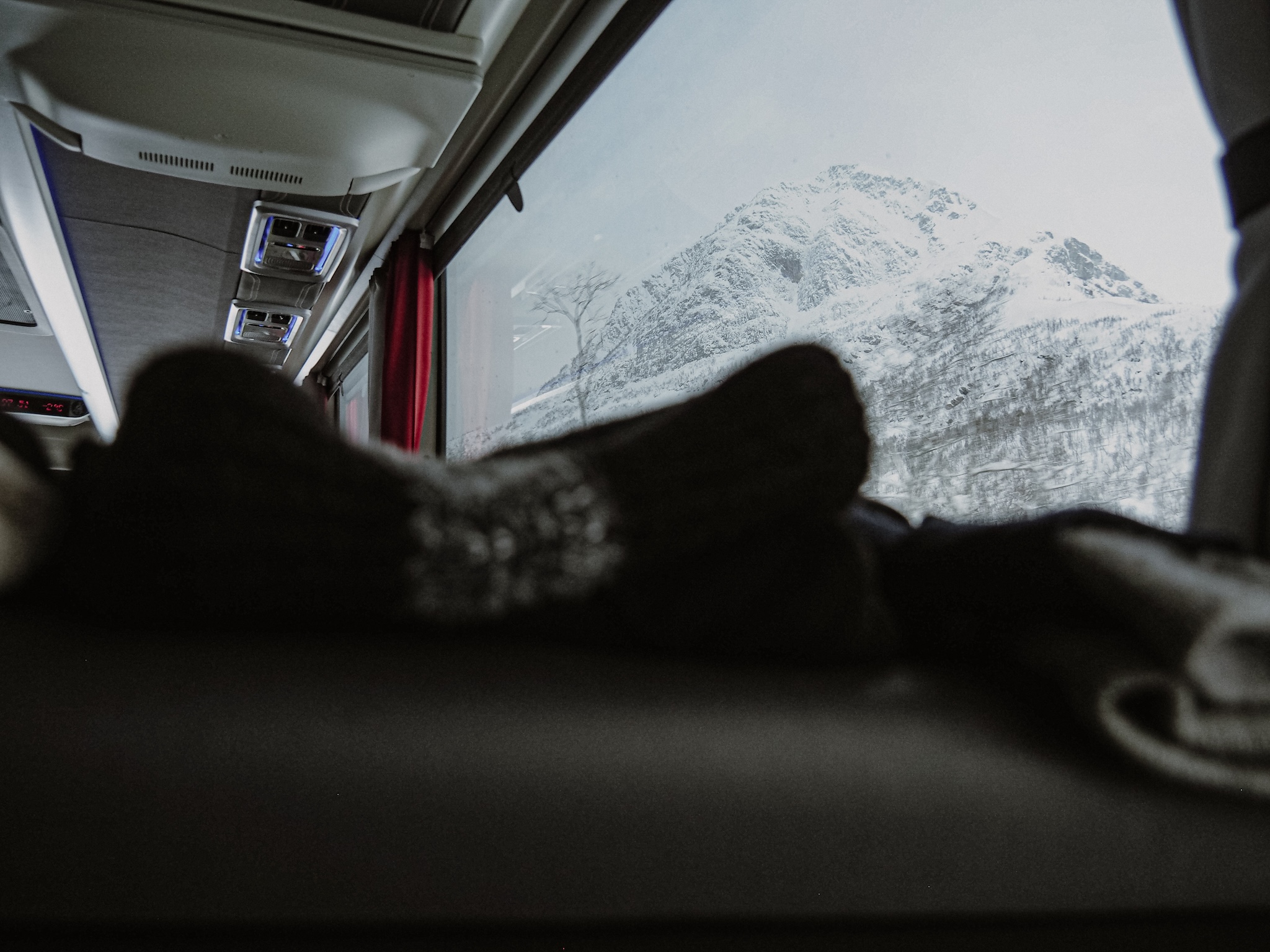 Snow-covered mountains seen from inside the Arctic Bus